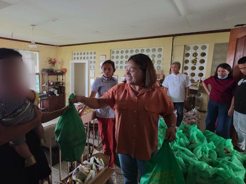 Pastor Hazel handing out relief packs to mothers and families