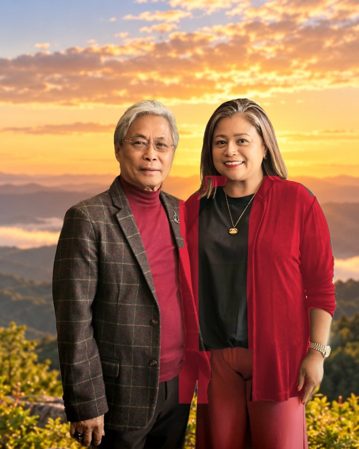 Pastors Ric and Hazel Saquing standing on a mountaintop at sunrise