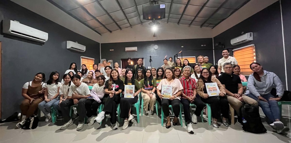 Pastors Ric and Hazel with Sunday School teachers and leaders holding their training materials
